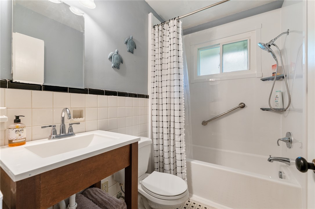 1105 Greenacres Anderson, SC 29621 - Photo 27 of 46 A well-maintained bathroom offers a clean vanity, bright shower/tub combo, and window for natural light.