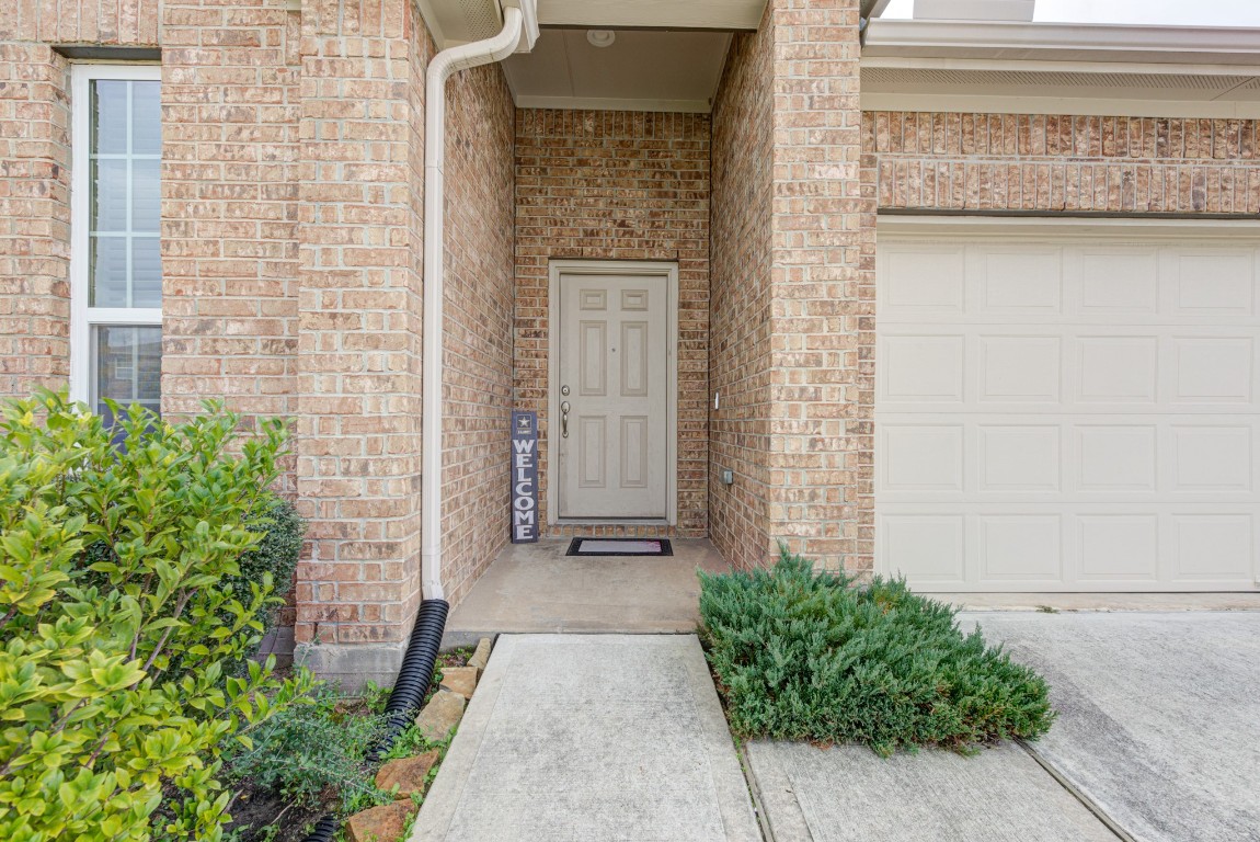 1510 Bella Garden Spring, TX 77373 - Photo 2 of 21 a view of a brick house with potted plants in front of door