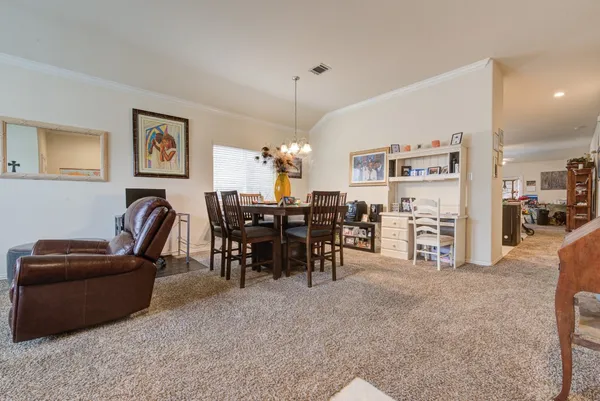 a living room with furniture and a dining table