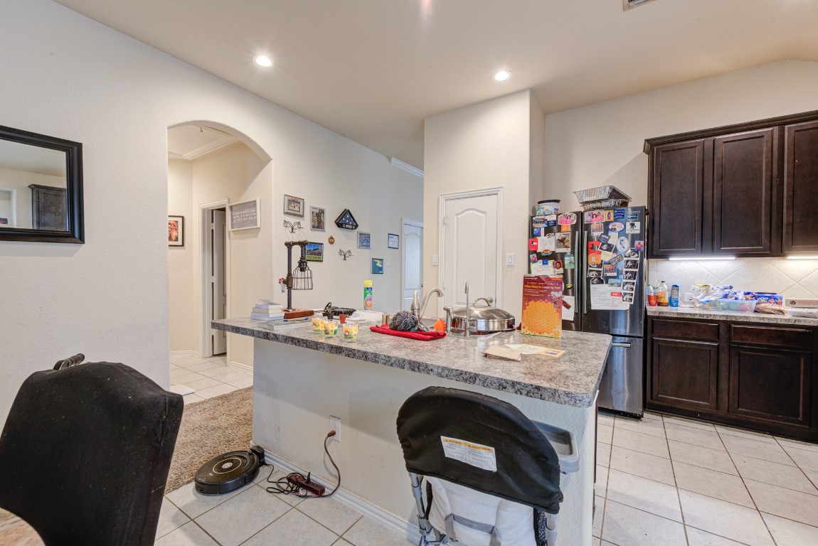 1510 Bella Garden Spring, TX 77373 - Photo 9 of 21 a kitchen with stainless steel appliances granite countertop a sink and a refrigerator