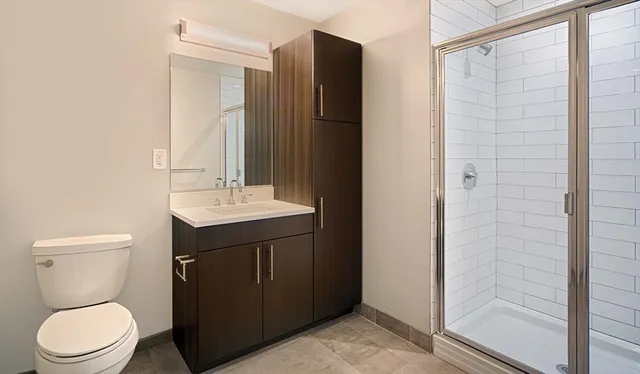 a bathroom with a sink toilet and shower