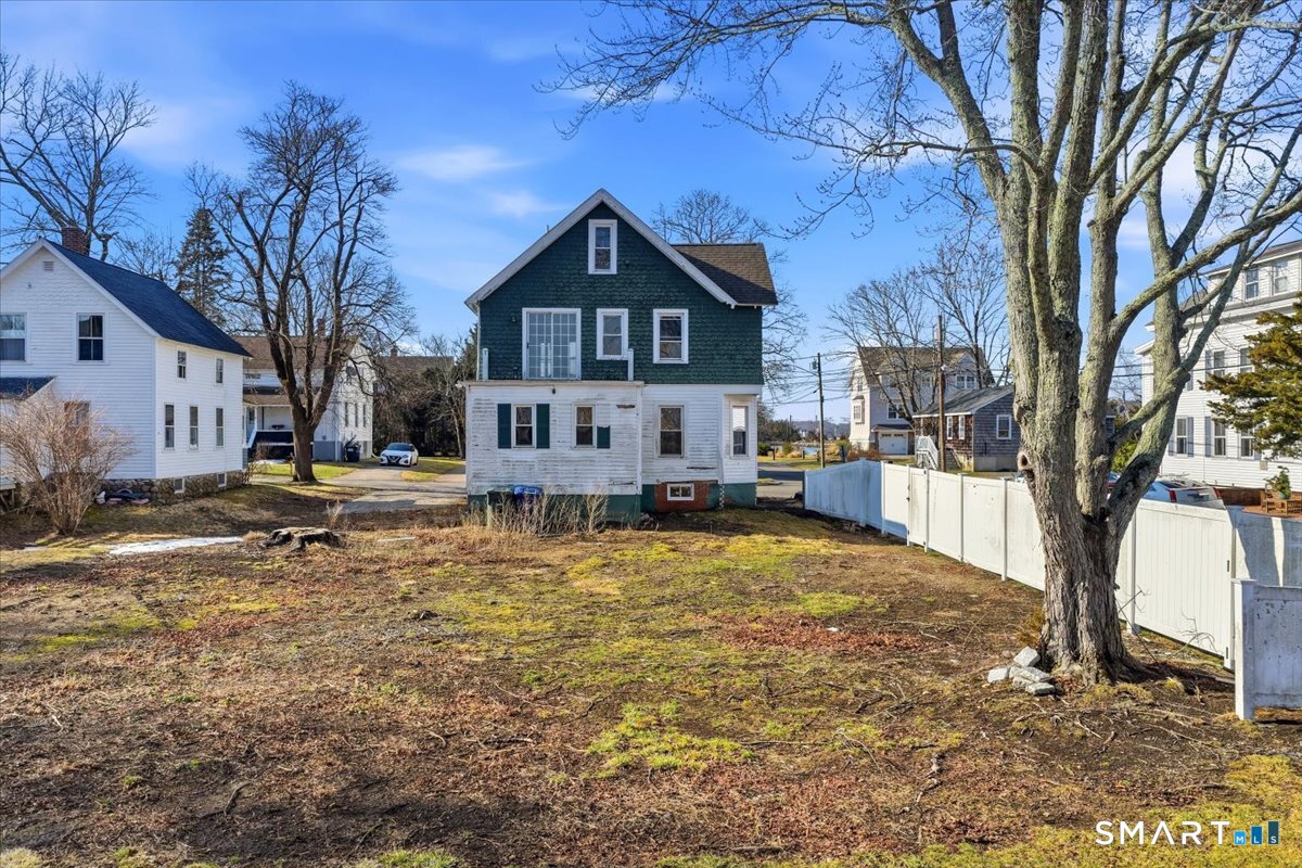 18 Maxson Street Groton, CT 06355 - Photo 2 of 39 a front view of a house with a yard covered with snow