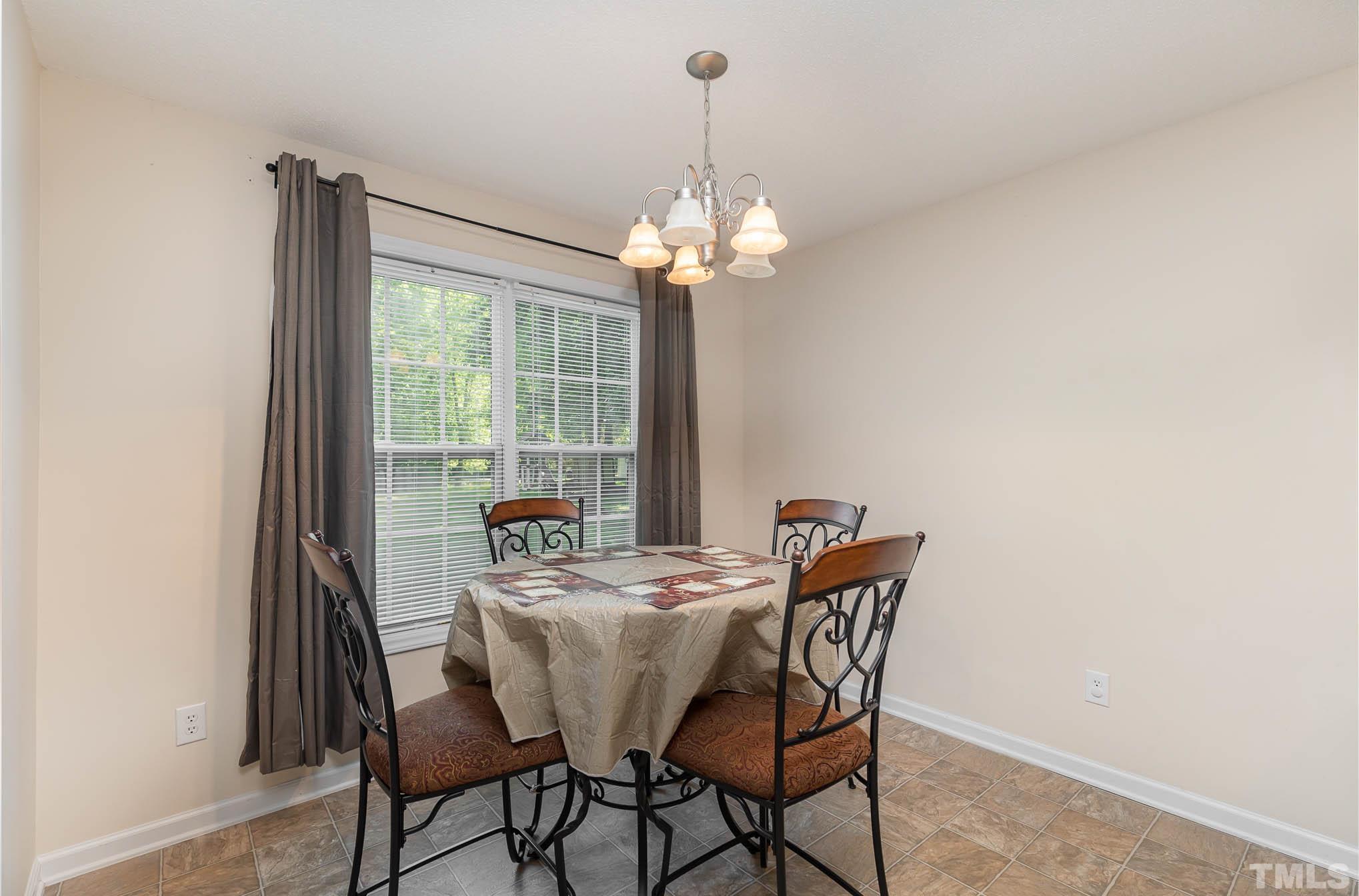 30 Rolling Cloud Drive Louisburg, NC 27549 - Photo 13 of 25 a dining room with furniture a chandelier and a rug