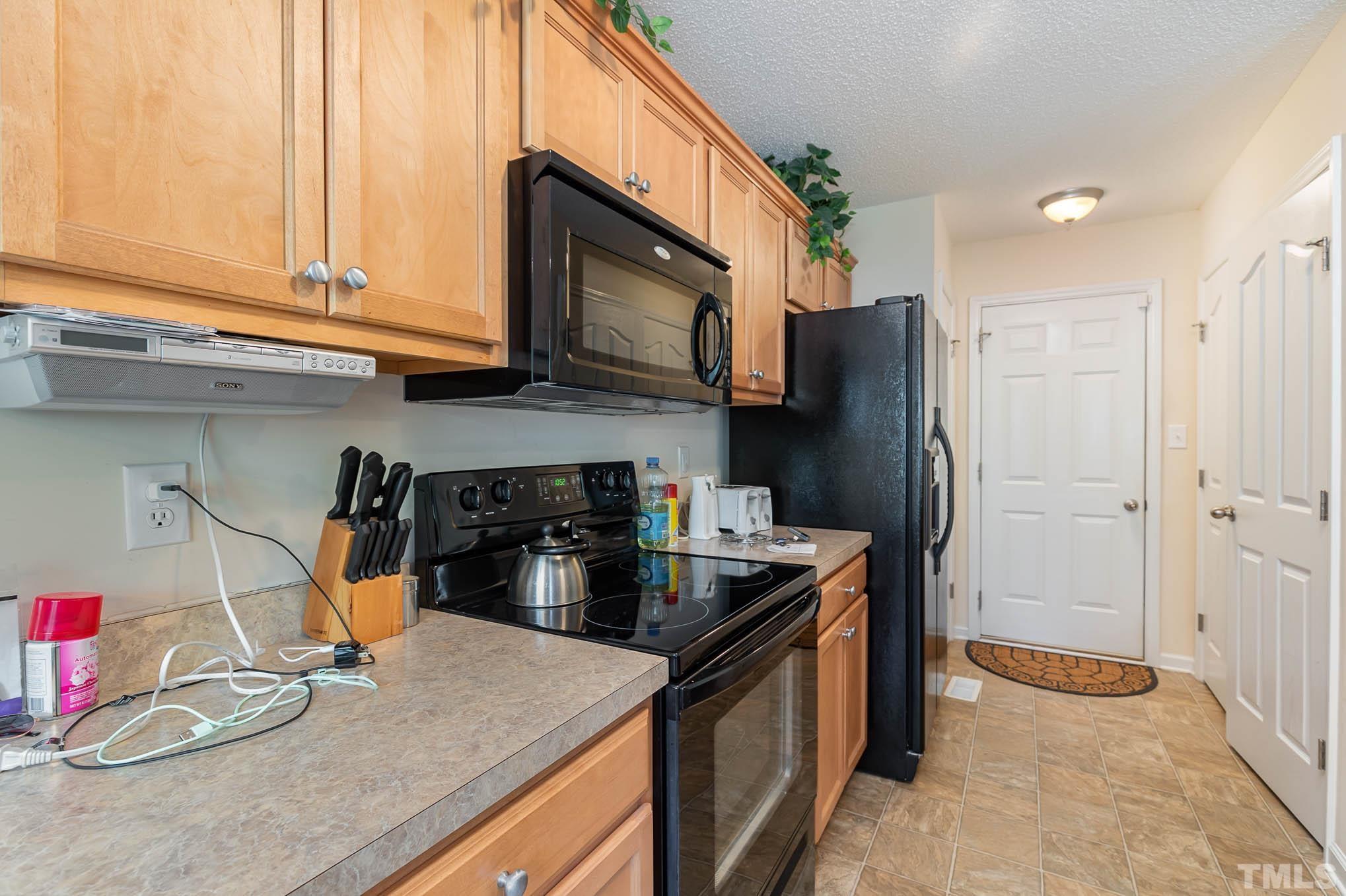 30 Rolling Cloud Drive Louisburg, NC 27549 - Photo 15 of 25 a kitchen with stainless steel appliances granite countertop a refrigerator a stove and a sink