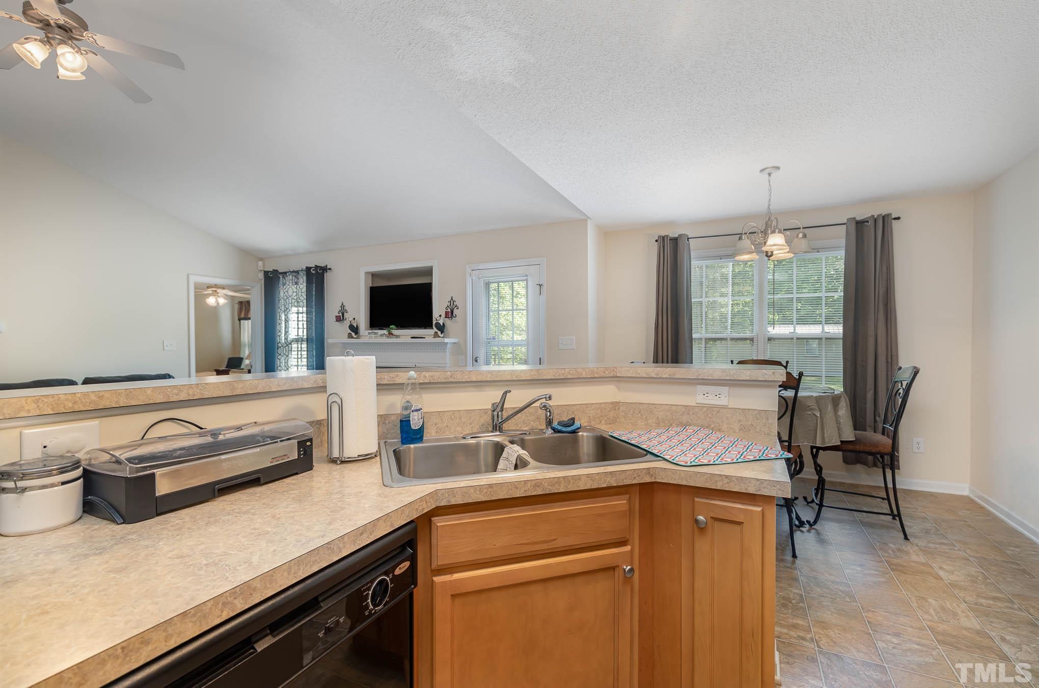 30 Rolling Cloud Drive Louisburg, NC 27549 - Photo 16 of 25 a kitchen with a sink a stove and chairs