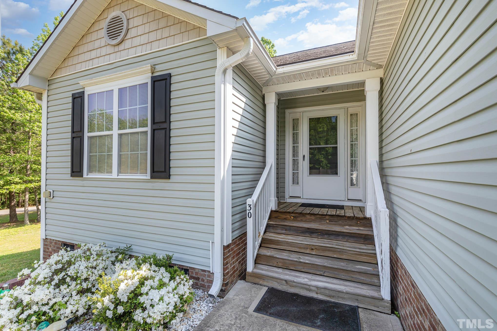 30 Rolling Cloud Drive Louisburg, NC 27549 - Photo 4 of 25 a view of a house with a window and flower plants
