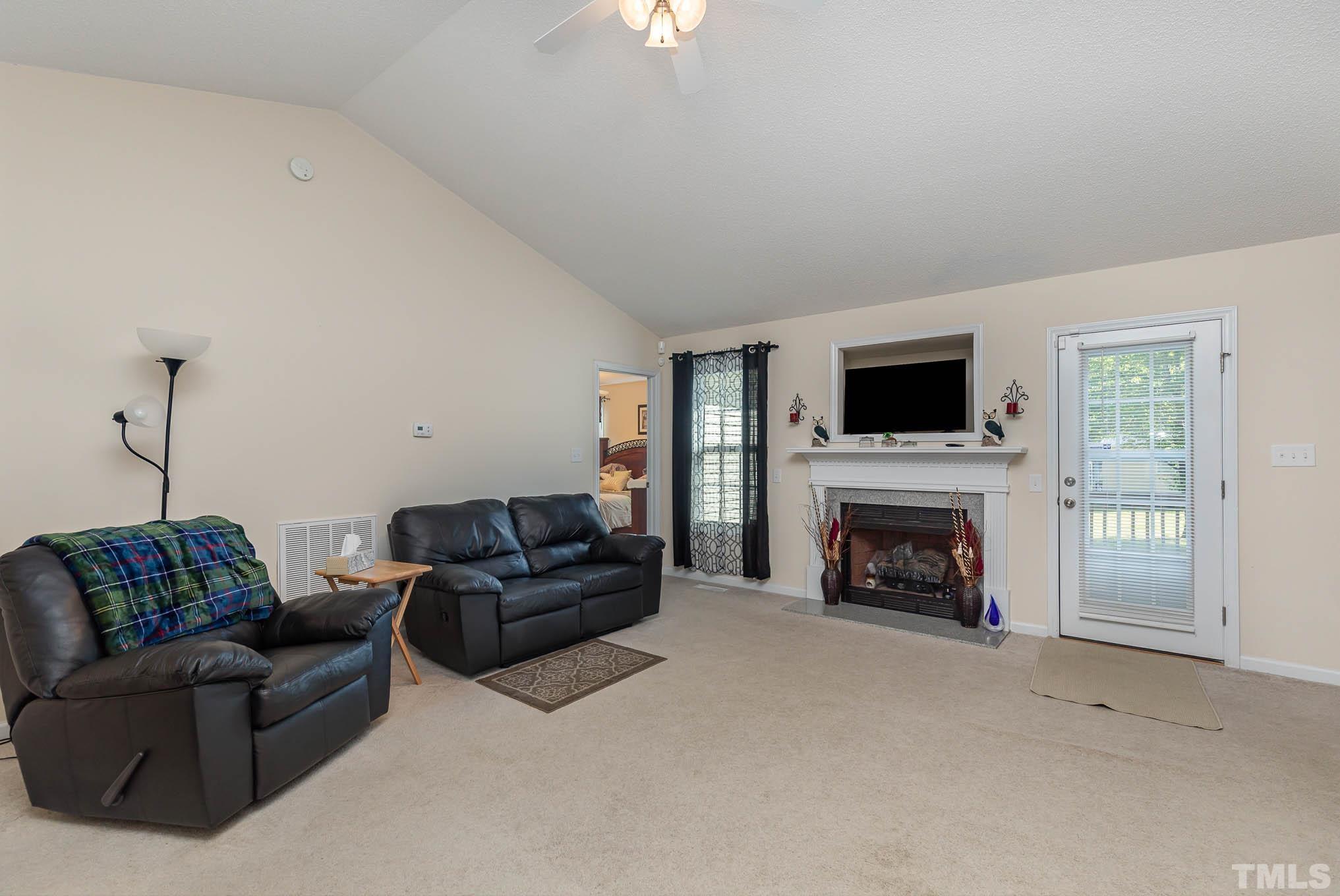 30 Rolling Cloud Drive Louisburg, NC 27549 - Photo 7 of 25 a living room with furniture and a fireplace