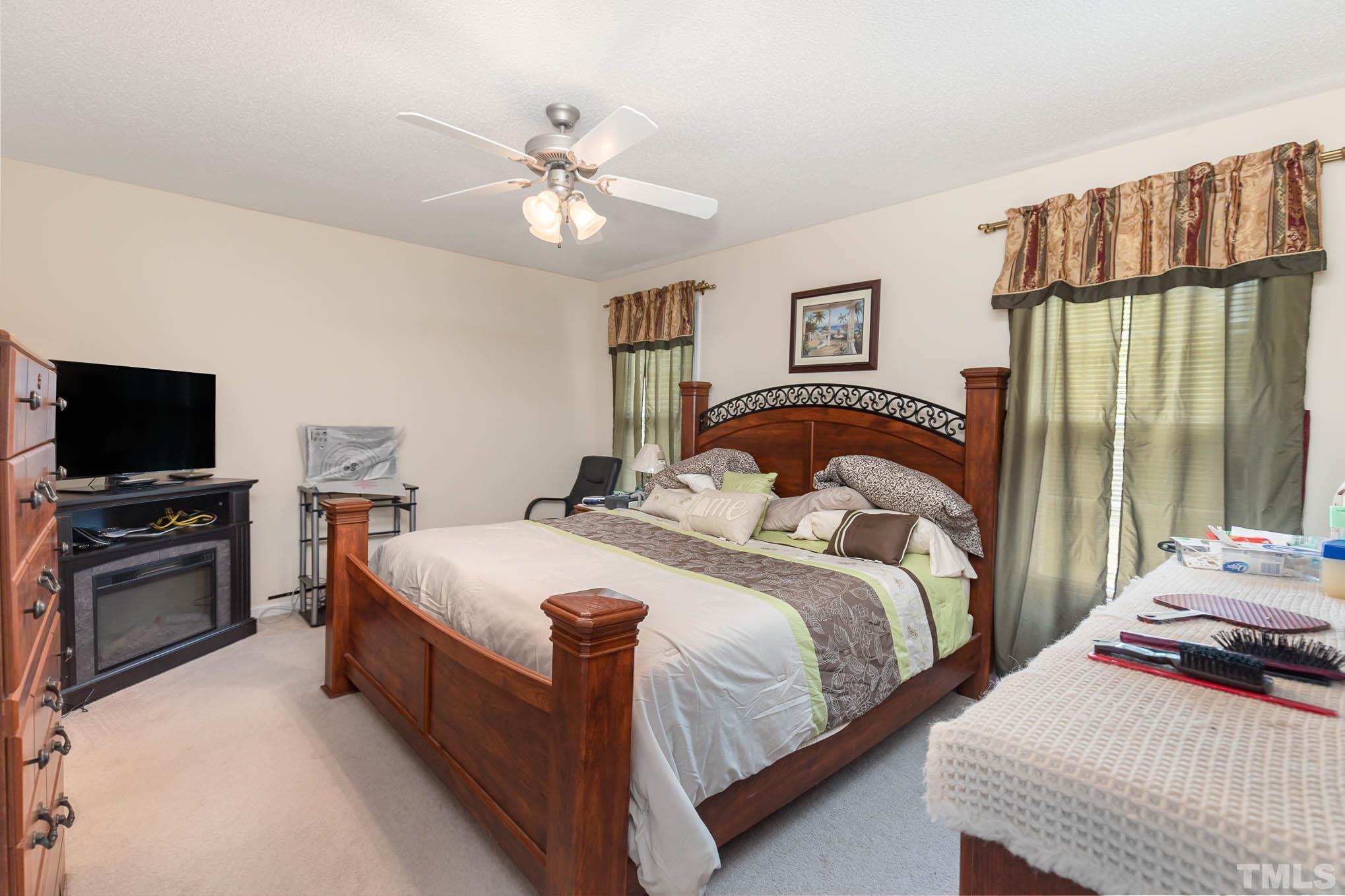 30 Rolling Cloud Drive Louisburg, NC 27549 - Photo 10 of 25 a bedroom with two beds and a chandelier