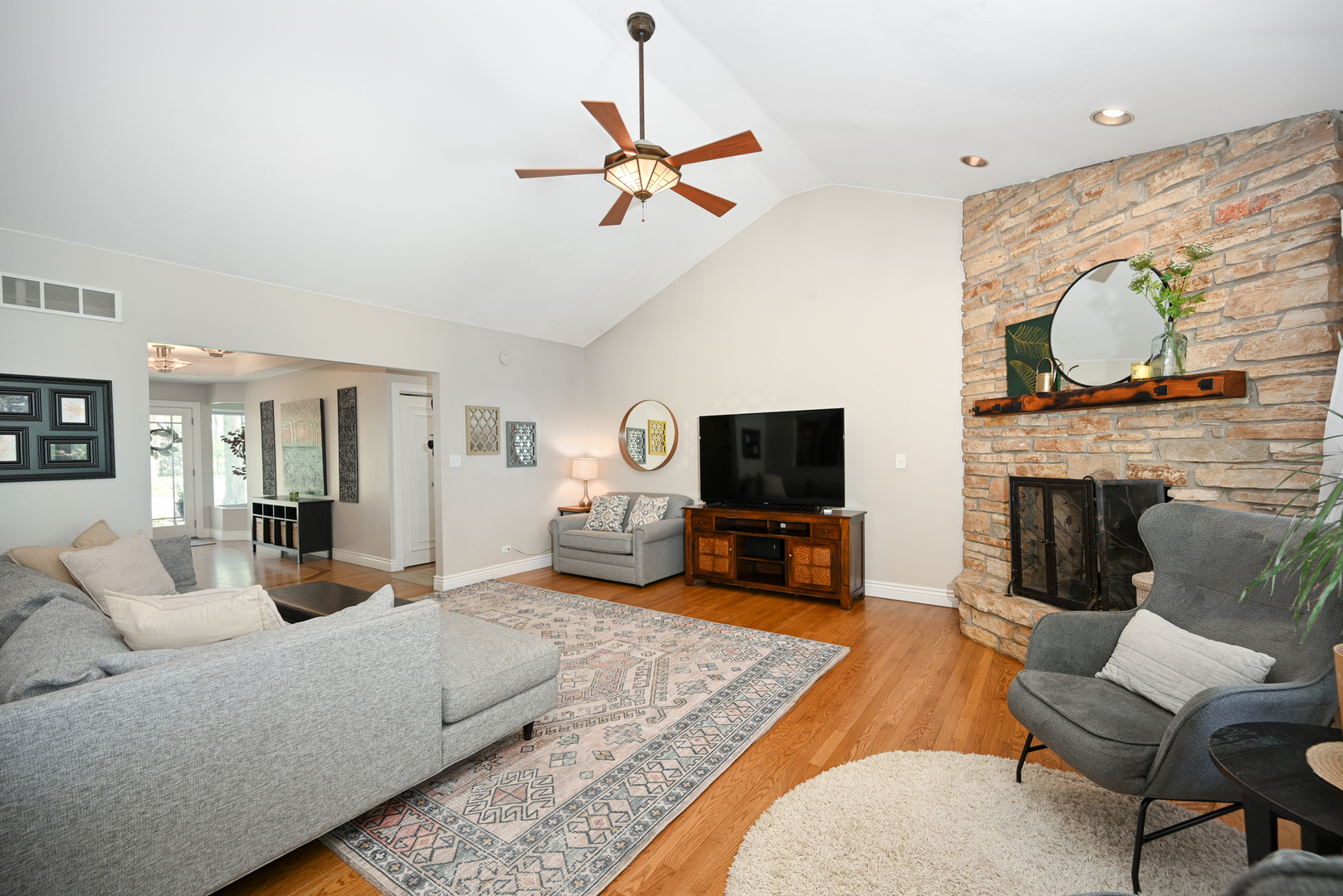 2588 # J Rock Creek Road Plano, IL 60545 - Photo 11 of 39 a living room with furniture a flat screen tv and a fireplace