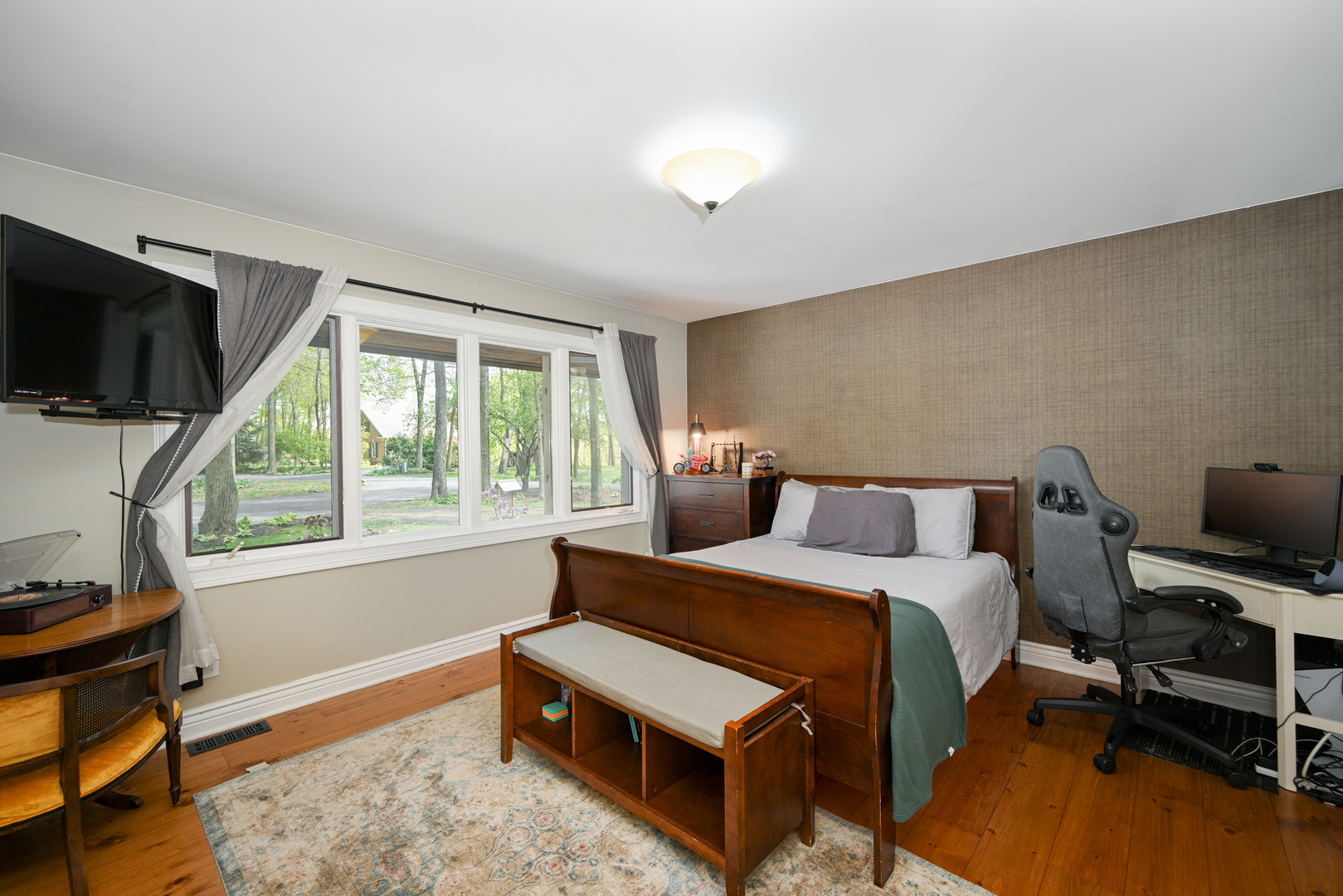 2588 # J Rock Creek Road Plano, IL 60545 - Photo 24 of 39 a bedroom with a bed a flat screen tv and a window