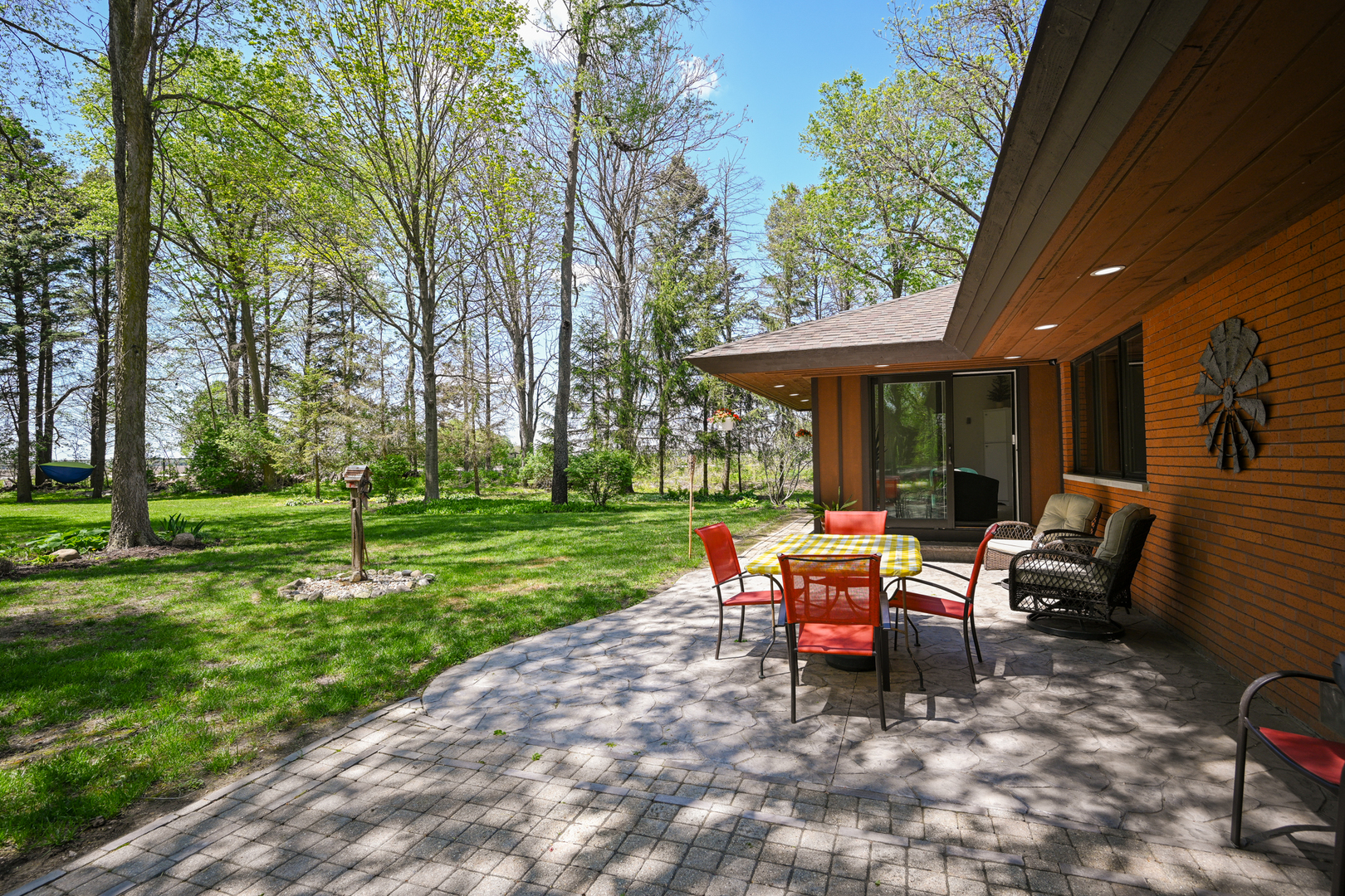 2588 # J Rock Creek Road Plano, IL 60545 - Photo 29 of 39 a view of a house with backyard sitting area and garden