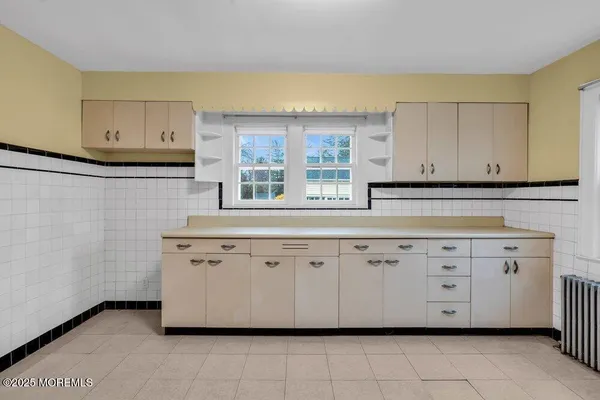 a kitchen with granite countertop white cabinets and sink