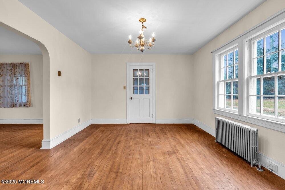 16 Robertsville Road Freehold, NJ 07728 - Photo 16 of 59 a view of an empty room with wooden floor and a window