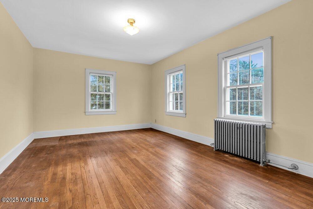 16 Robertsville Road Freehold, NJ 07728 - Photo 18 of 59 an empty room with wooden floor and windows