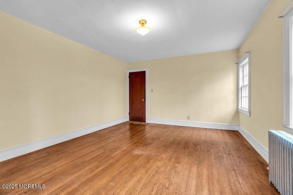 16 Robertsville Road Freehold, NJ 07728 - Photo 23 of 59 a view of an empty room with wooden floor and a window