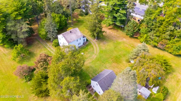 a view of a big yard with a house in the background