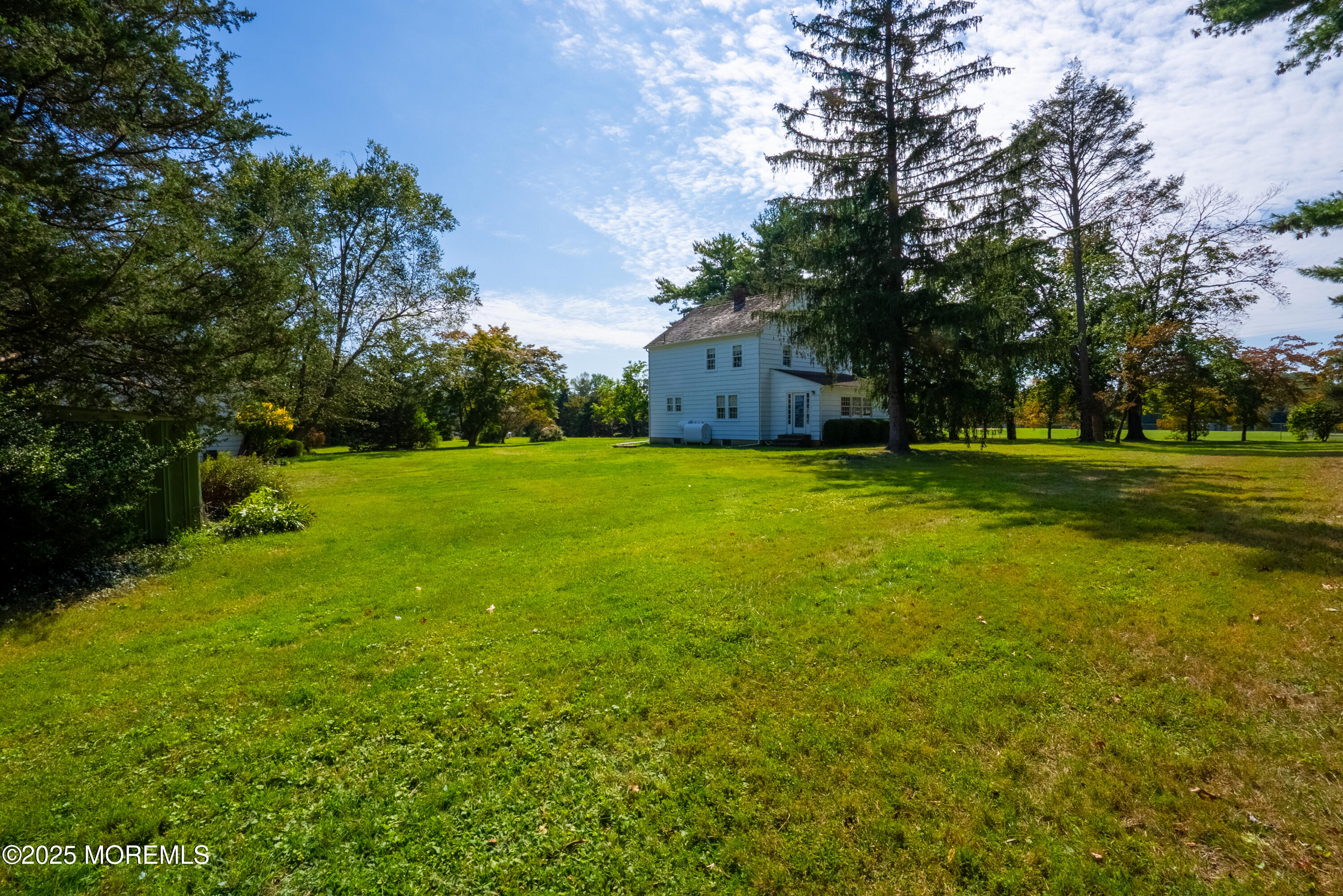 16 Robertsville Road Freehold, NJ 07728 - Photo 43 of 59 a view of a big yard with a house and large trees