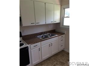 1750 Haskin Road, Unit 1 Goochland, VA 23063 - Photo 3 of 8 a kitchen with granite countertop white cabinets and black appliances