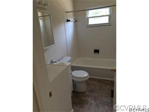 1750 Haskin Road, Unit 1 Goochland, VA 23063 - Photo 7 of 8 a bathroom with a granite countertop toilet and a shower