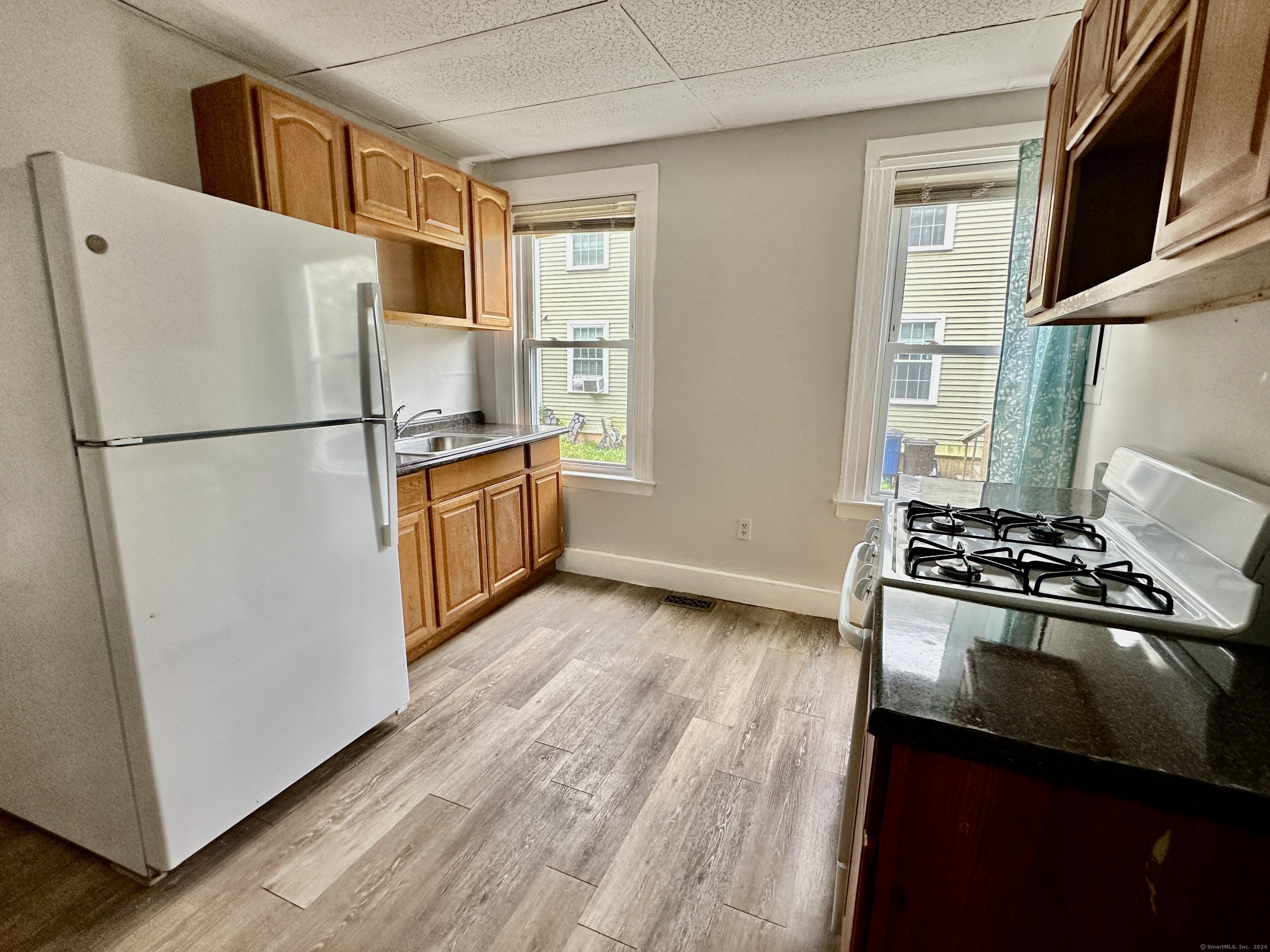 585 Winchester Avenue, Unit 1 New Haven, CT 06511 - Photo 2 of 12 a white refrigerator freezer and a stove sitting inside of a kitchen