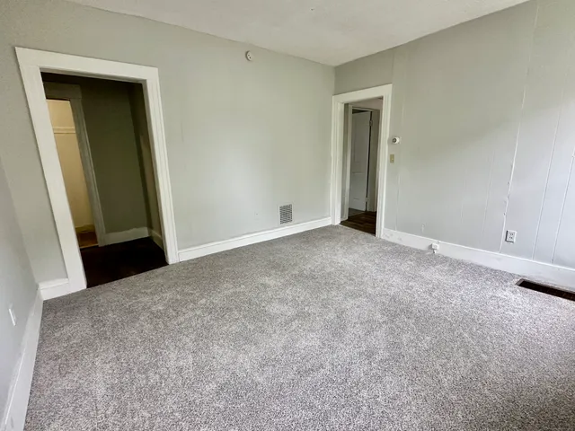 a view of an empty room and closet area