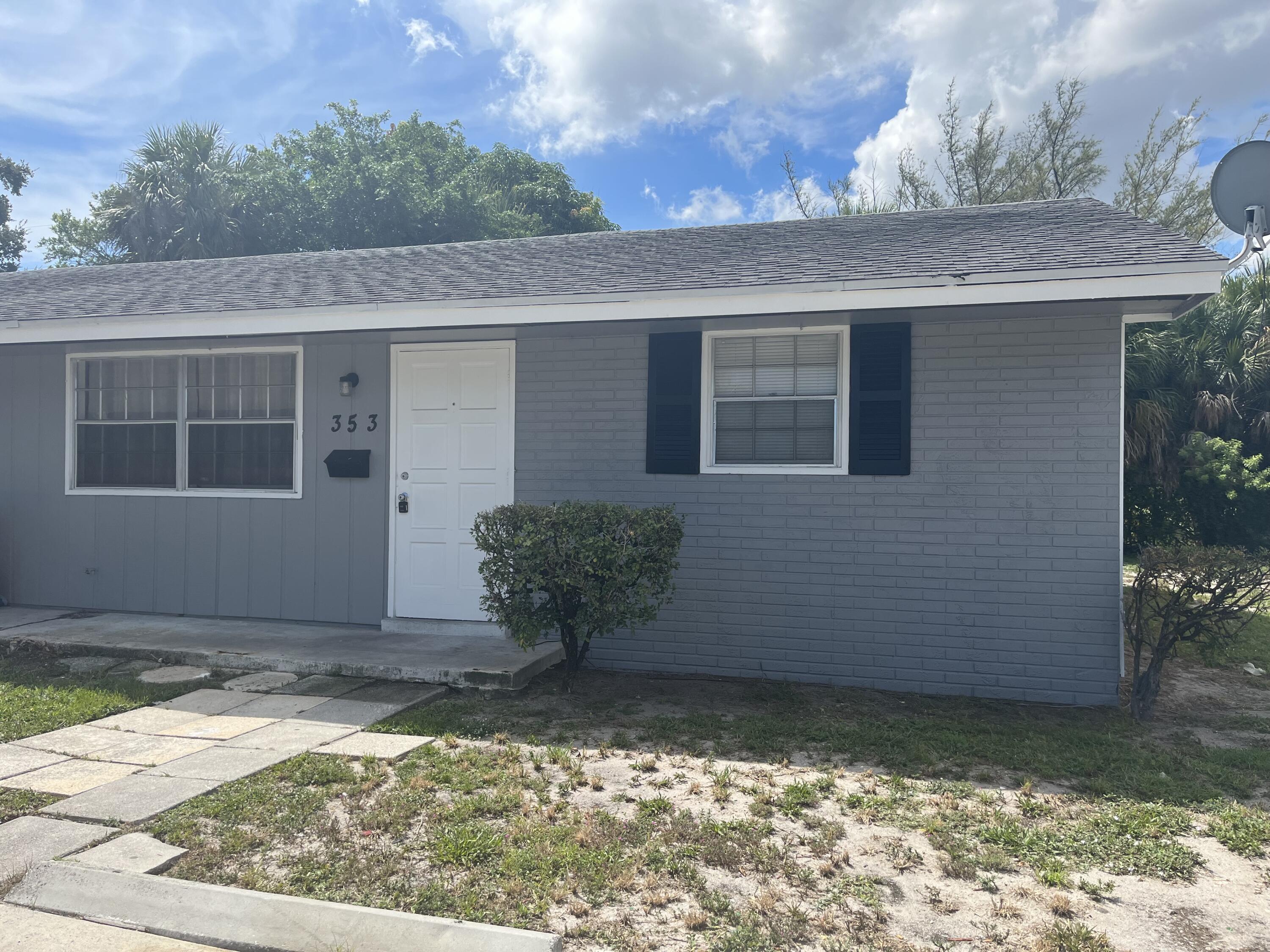 353 Silver Beach Road Riviera Beach, FL 33403 - Photo 1 of 10 a view of a house with a yard