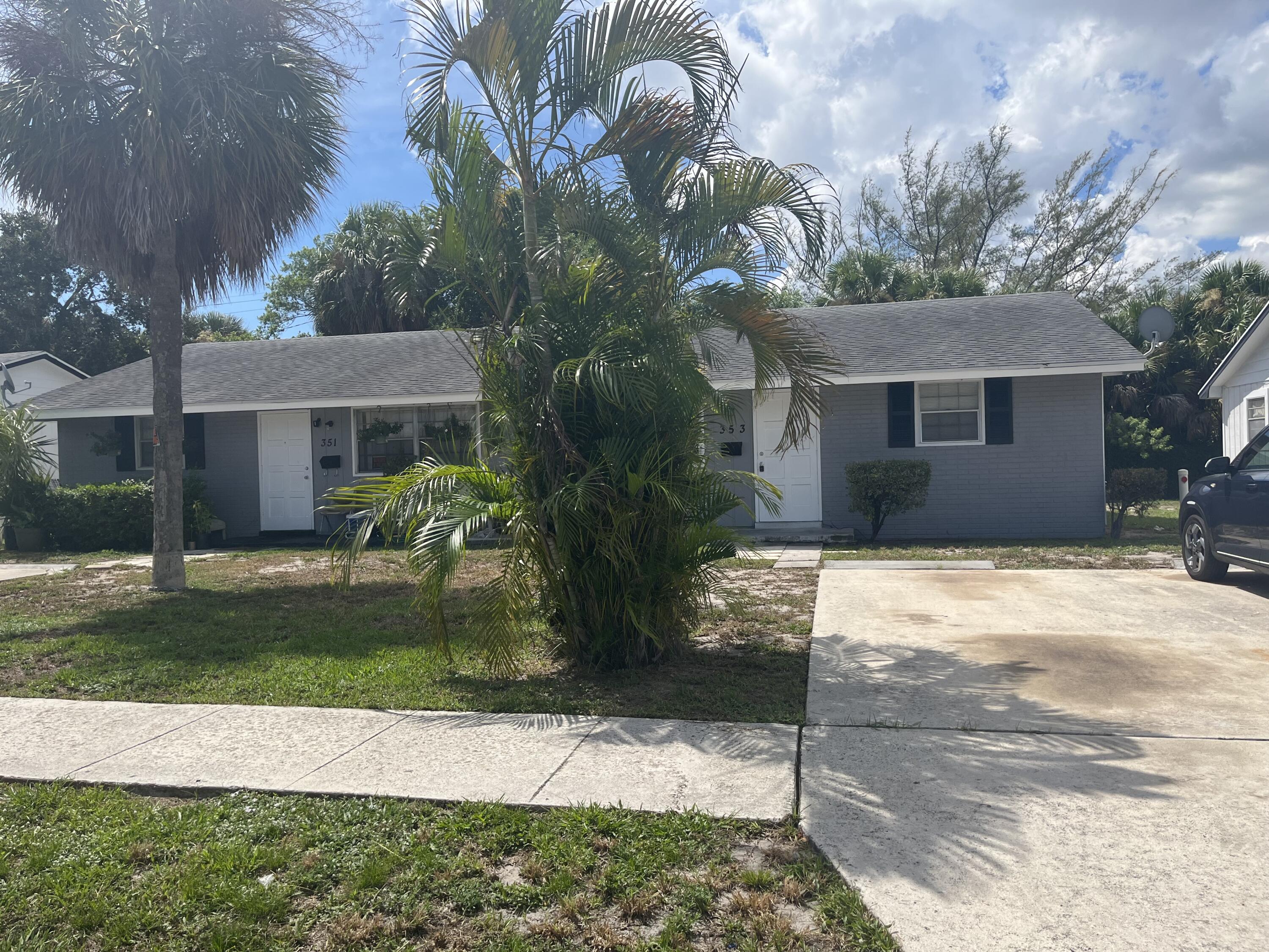 353 Silver Beach Road Riviera Beach, FL 33403 - Photo 2 of 10 a front view of a house with garden