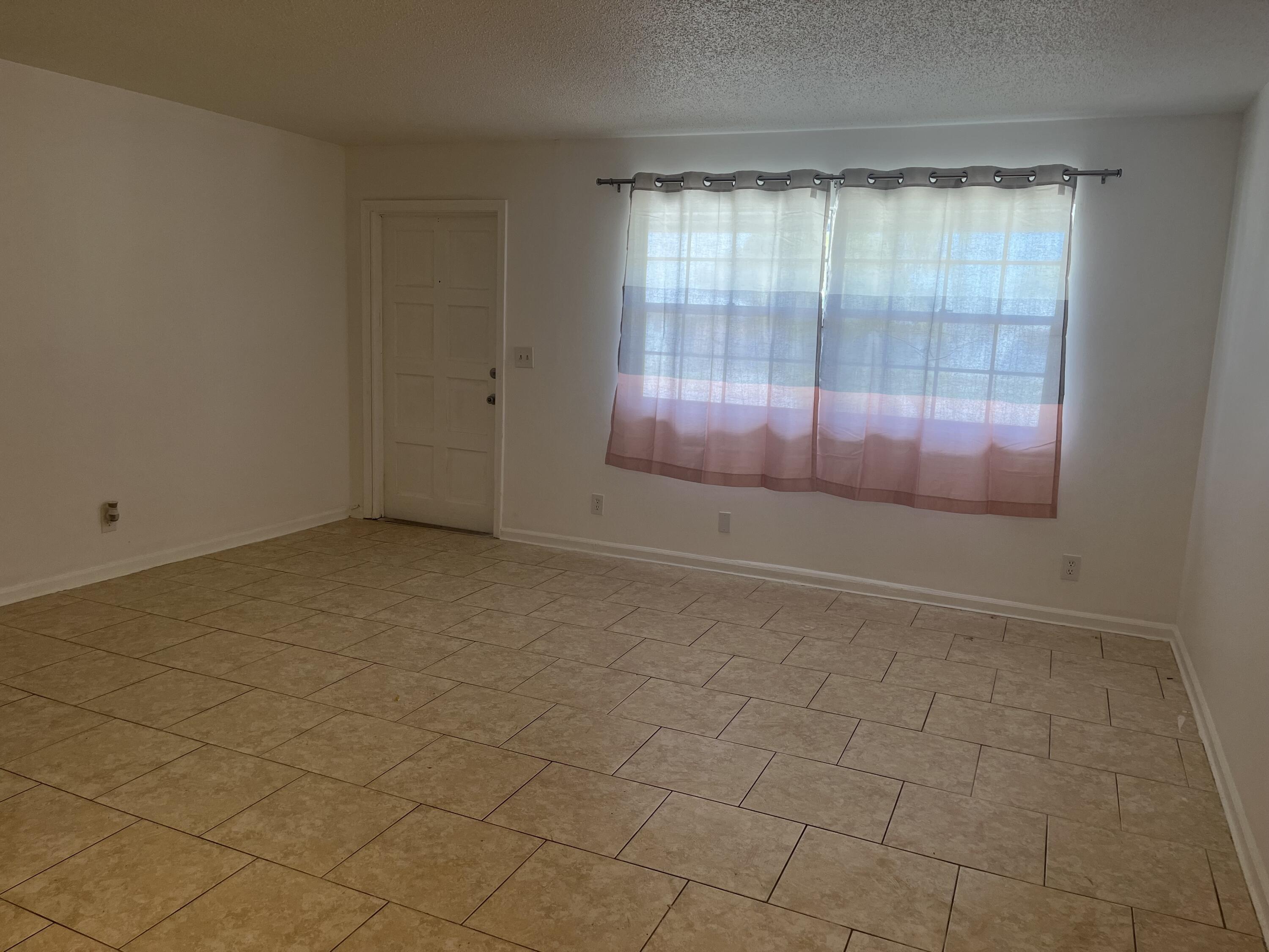 353 Silver Beach Road Riviera Beach, FL 33403 - Photo 5 of 10 an empty room with windows