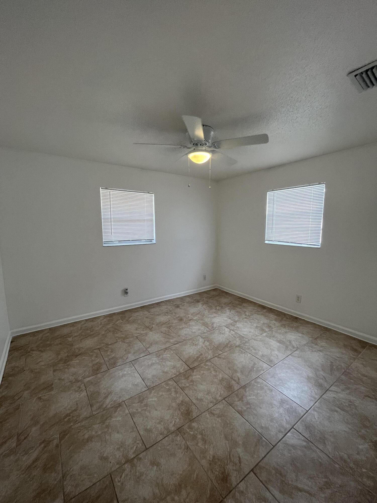 353 Silver Beach Road Riviera Beach, FL 33403 - Photo 8 of 10 a view of an empty room with a window