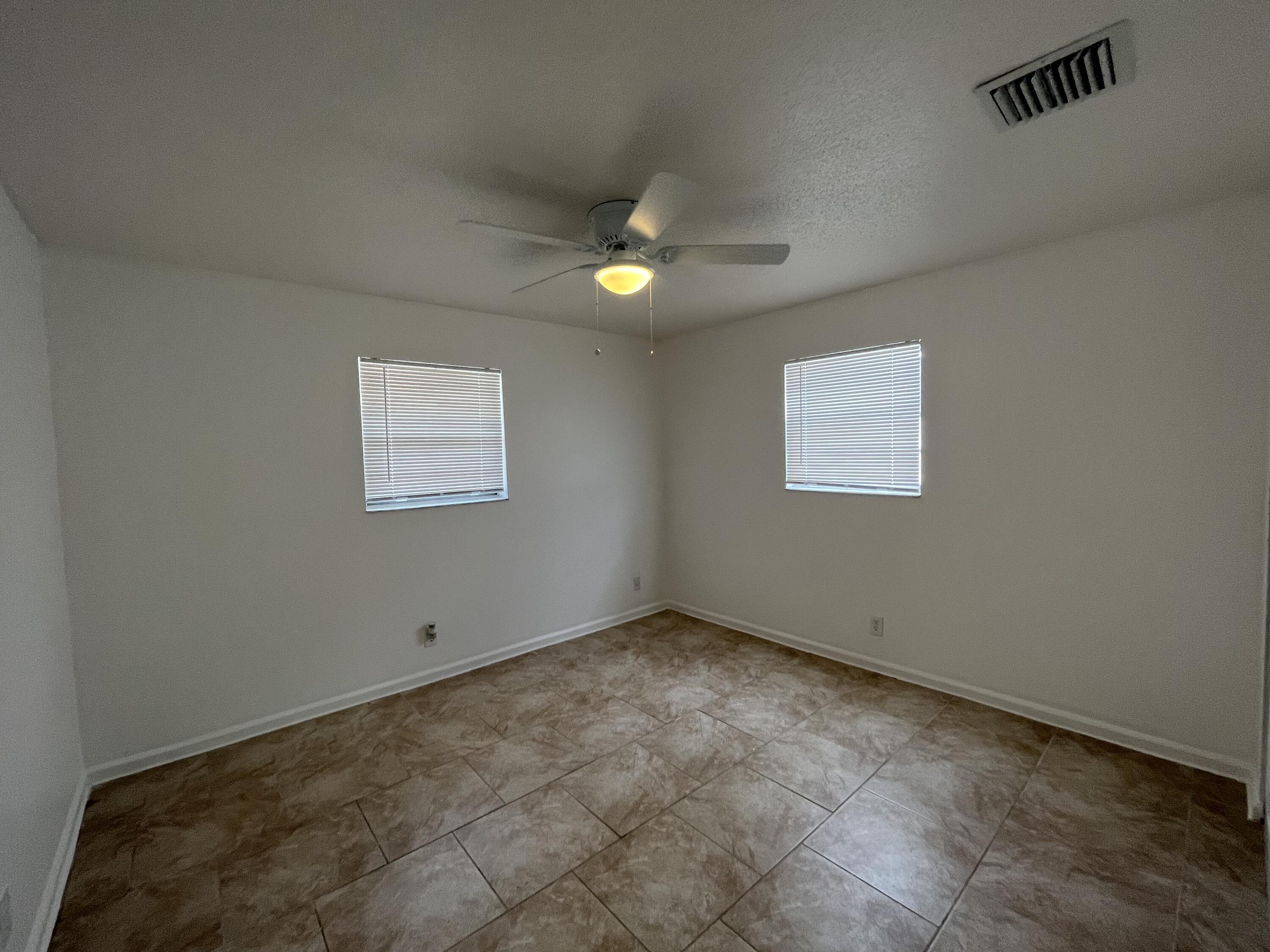 353 Silver Beach Road Riviera Beach, FL 33403 - Photo 9 of 10 an empty room with a window
