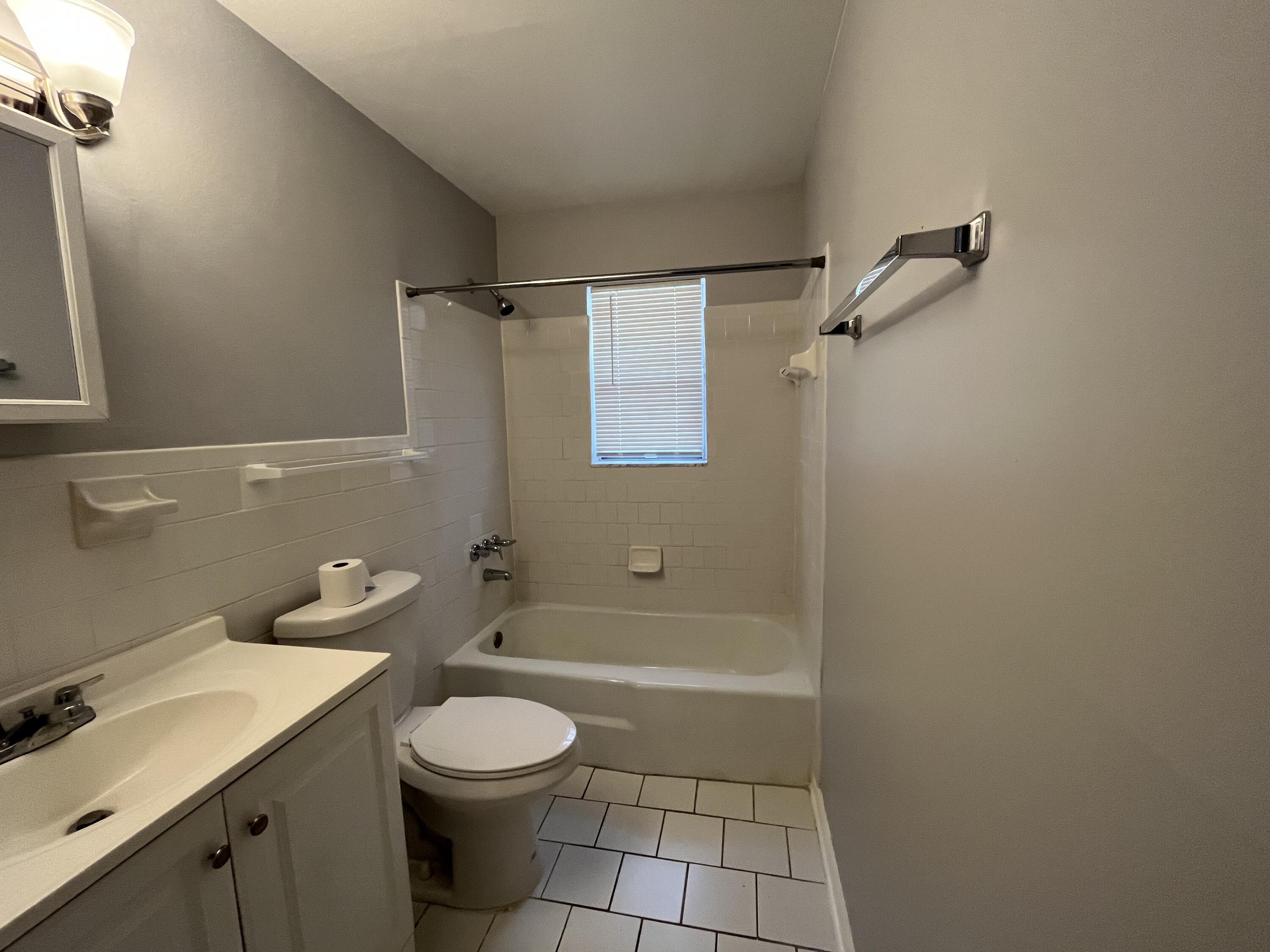 353 Silver Beach Road Riviera Beach, FL 33403 - Photo 10 of 10 a bathroom with a sink a toilet and shower
