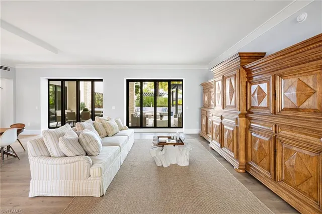 a living room with furniture tv and a large window