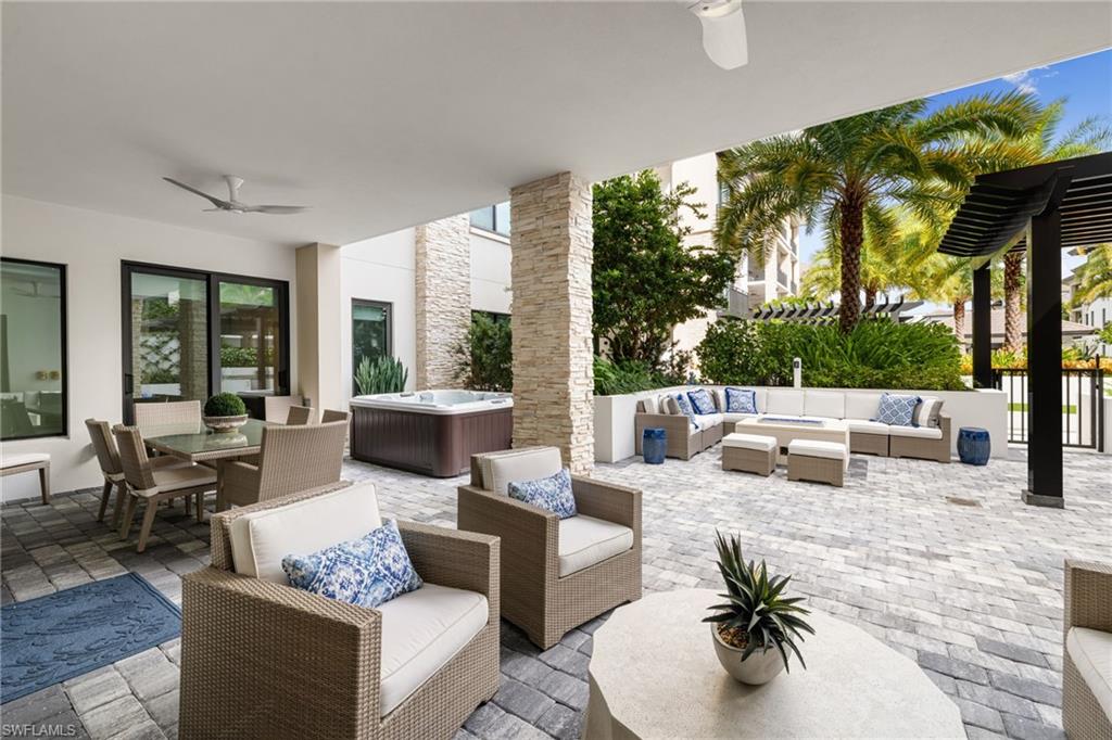 1130 3rd Avenue South, Unit 208 Naples, FL 34102 - Photo 2 of 48 a living room with furniture and a large window