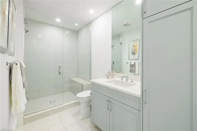 a bathroom with a shower sink vanity granite and shower