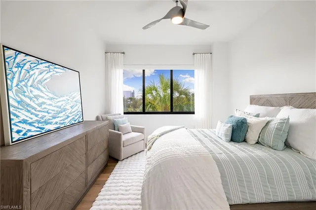 a bedroom with a large bed and a large window