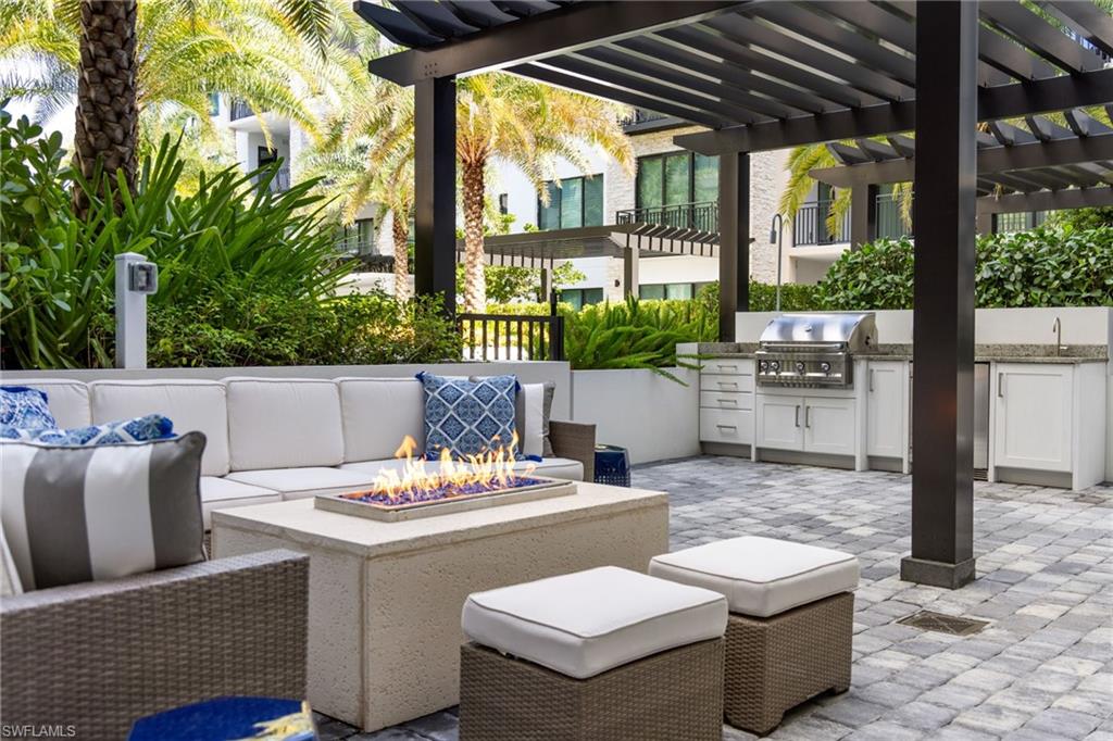 1130 3rd Avenue South, Unit 208 Naples, FL 34102 - Photo 7 of 48 a outdoor dining space with furniture and garden view