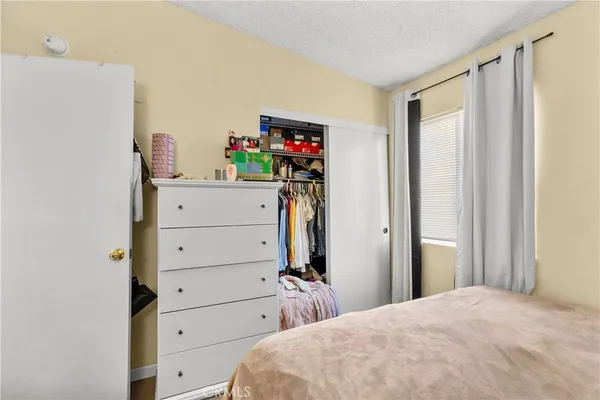 a bedroom with a bed and a closet