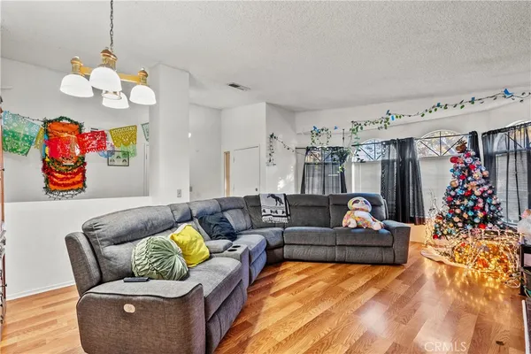 a living room with furniture kitchen and a chandelier