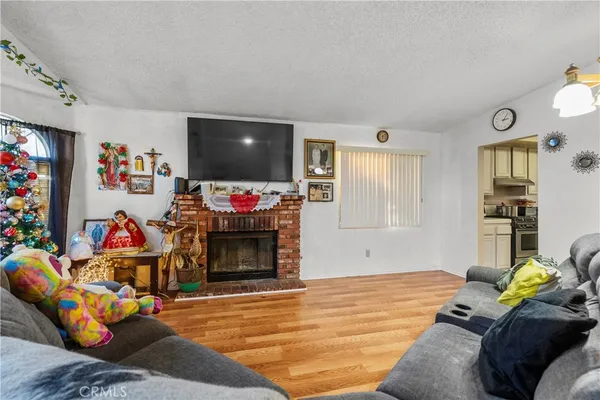 a living room with furniture a flat screen tv and a window
