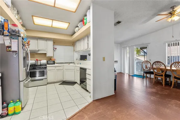 a kitchen with stainless steel appliances a refrigerator and a dining table