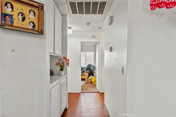 a hallway with painting on the wall