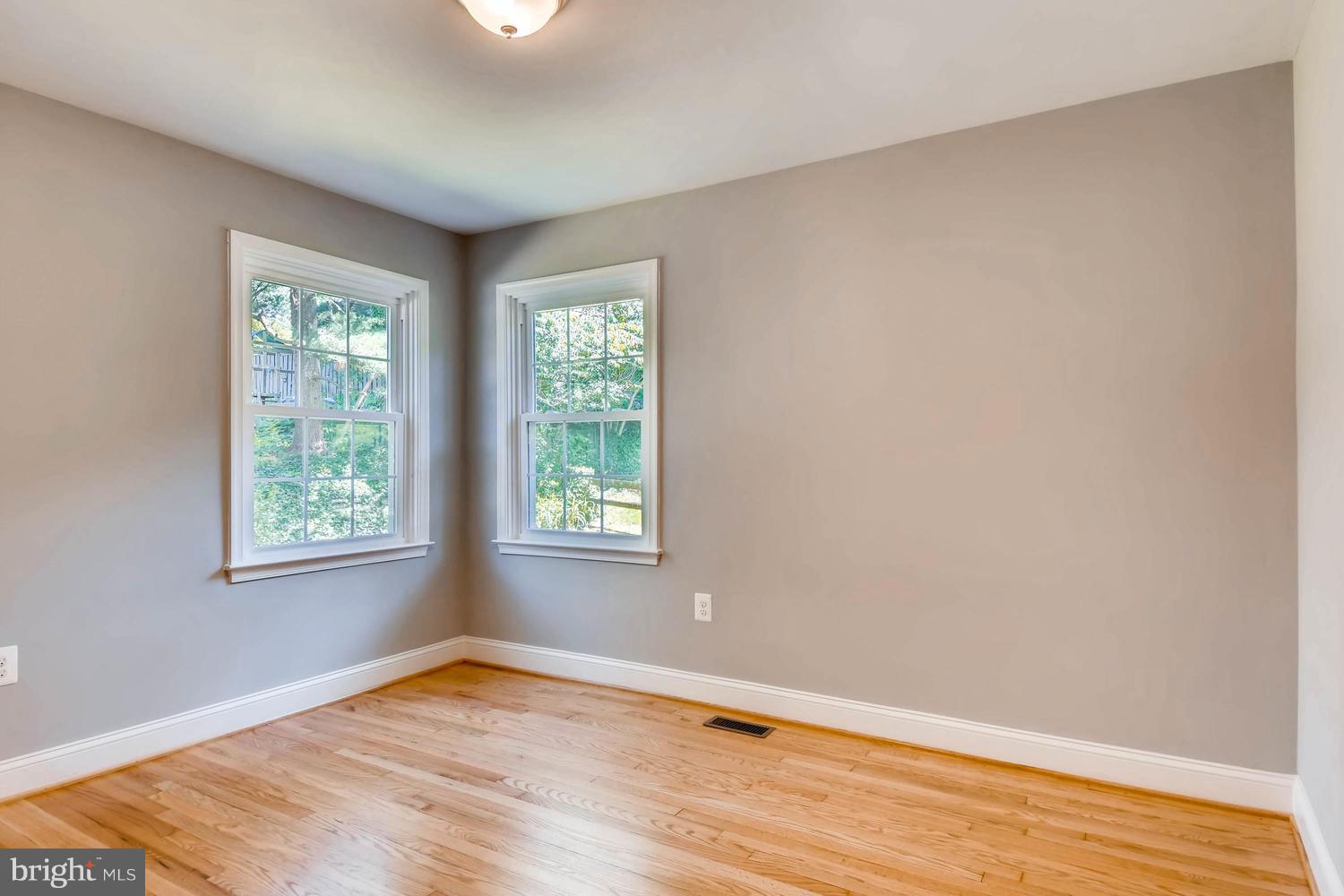 817 Ridgeleigh Road Baltimore, MD 21212 - Photo 22 of 25 a view of an empty room with wooden floor and a window