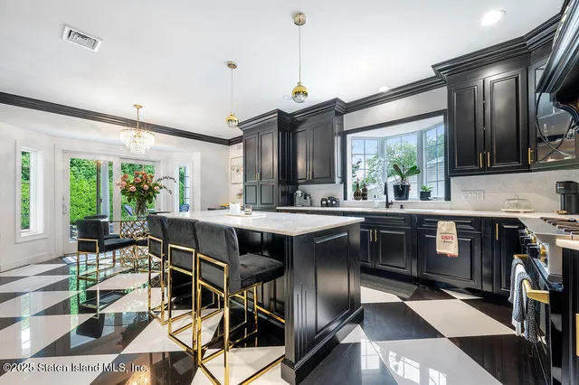 a kitchen with a table chairs sink and cabinets