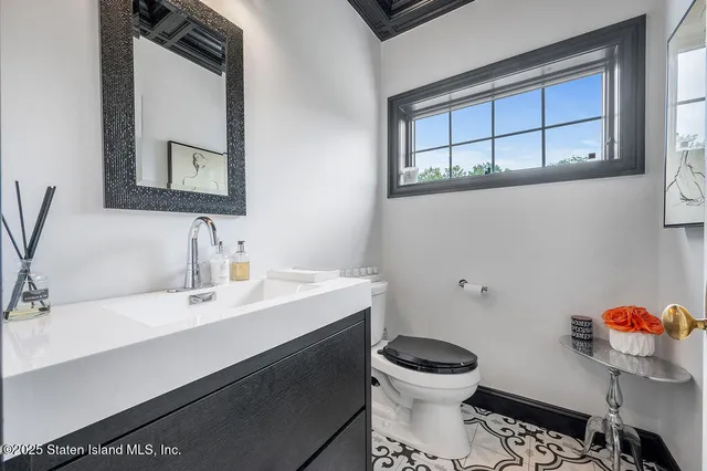 a bathroom with a toilet a sink and mirror
