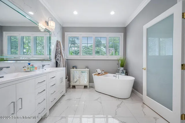 a bathroom with a bathtub sink and mirror