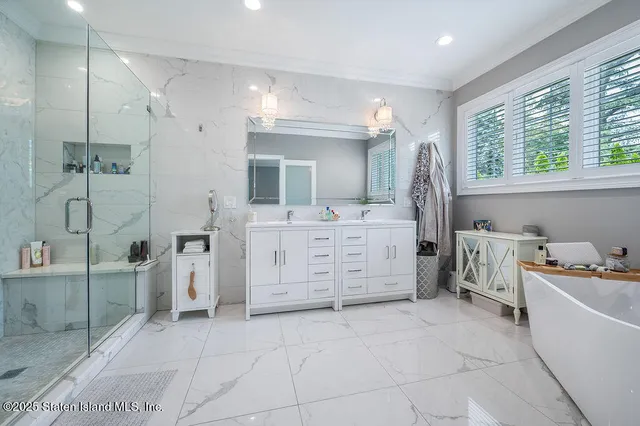 a bathroom with a tub sink and mirror