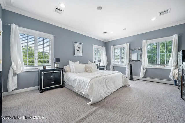 a spacious bedroom with a bed and a couch