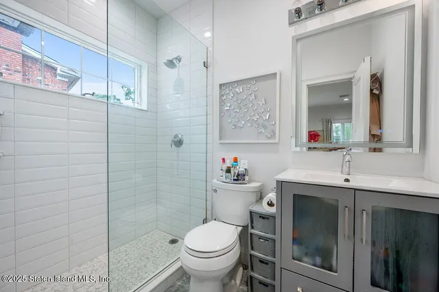 a bathroom with a toilet sink and shower