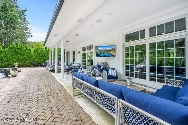 a balcony with furniture and garden view