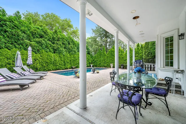 a dining room with furniture and garden view
